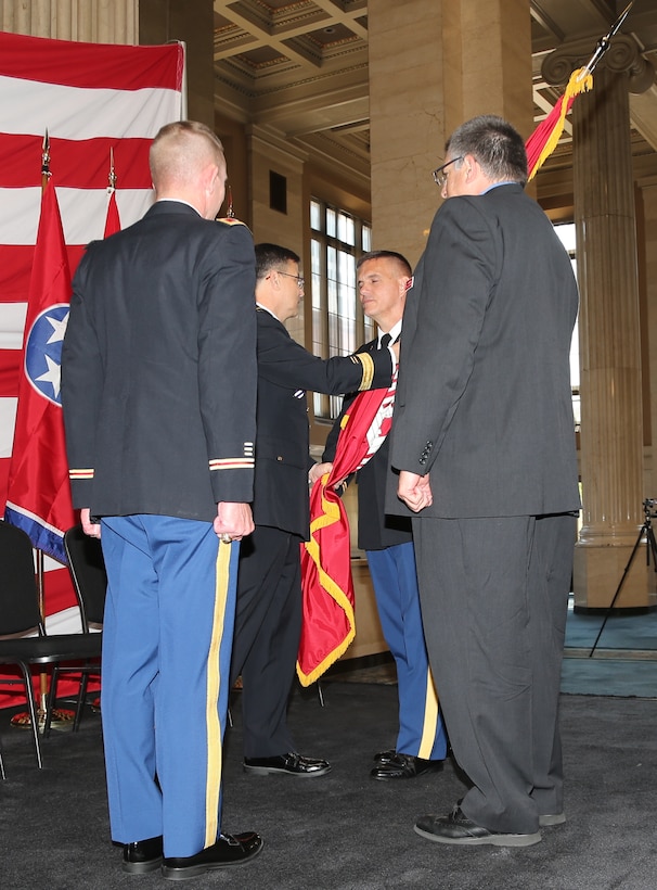 July 12, 2013 - Major General John W. Peabody, Commander of the Mississippi Valley Division and President of the Mississippi River Commission, placed the Corps of Engineers flag, transferring command of the Corps' Memphis District, into Col. Jeffery A. Anderson's hands during a Change of Command ceremony.  (Photo by Alfred Dulaney)