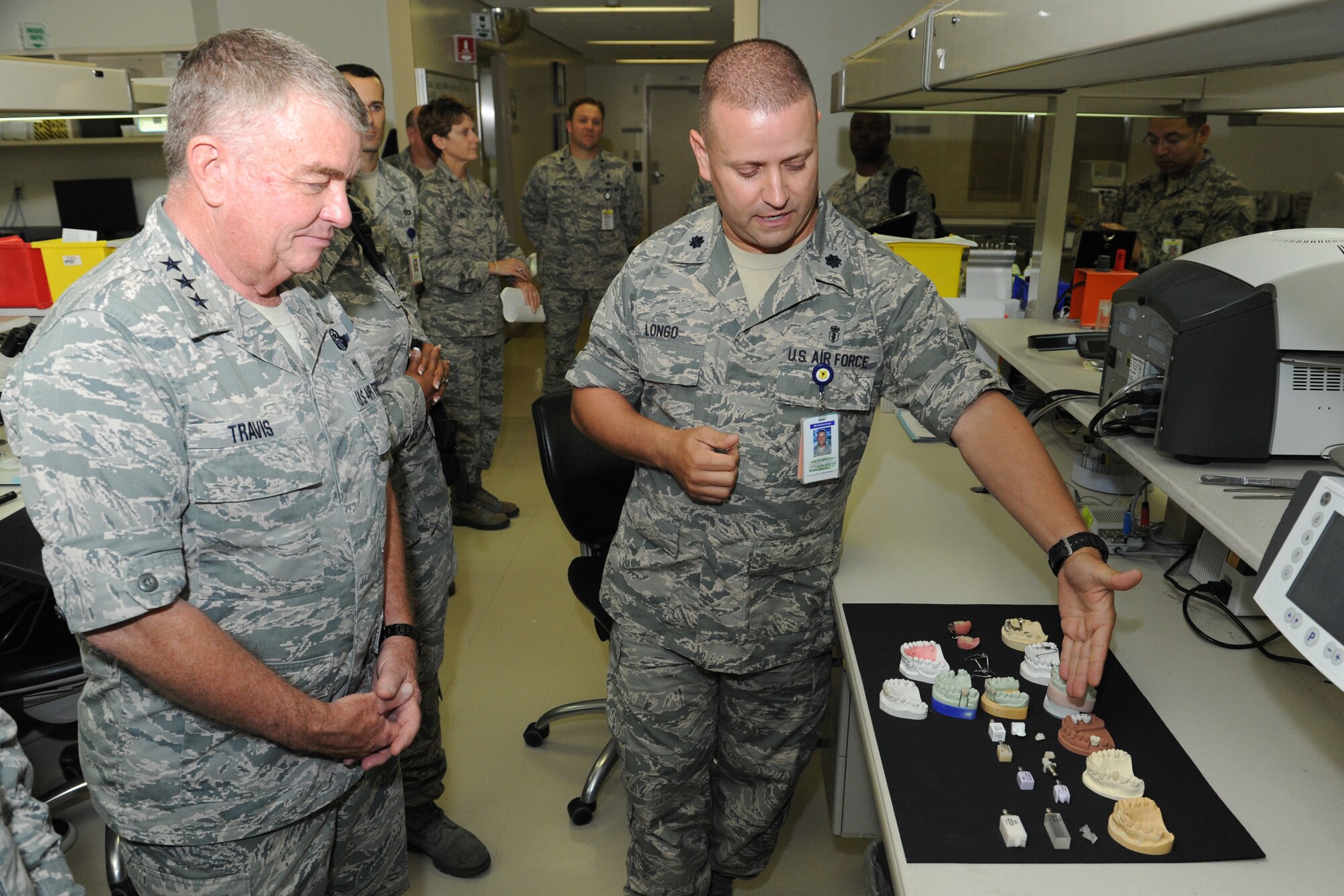 U.S. Air Force Lt. Col. Paul Longo, Area dental laboratory flight commander, shows Lt. Gen. (Dr.) Thomas Travis, Air Force Surgeon General, Headquarters U.S. Air Force, Washington, D.C., the different types of prostheses patients can be provided with on Kadena Air Base, Japan, July 16, 2013. Travis visited the medical clinic to learn more about the mission and interact with Airmen and staff, while also gaining an understanding of the new measures and methods being implemented to provide care for patients. (U.S. Air Force photo by Airman 1st Class Keith A. James/Released)