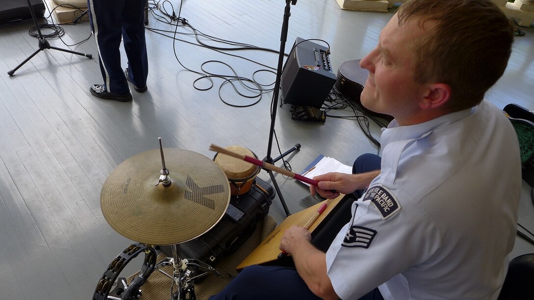 SSgt B.J. Richard keeps the beat for "Small Kine" with a small set up of just a cajon, high hat, and a tambourine! 


