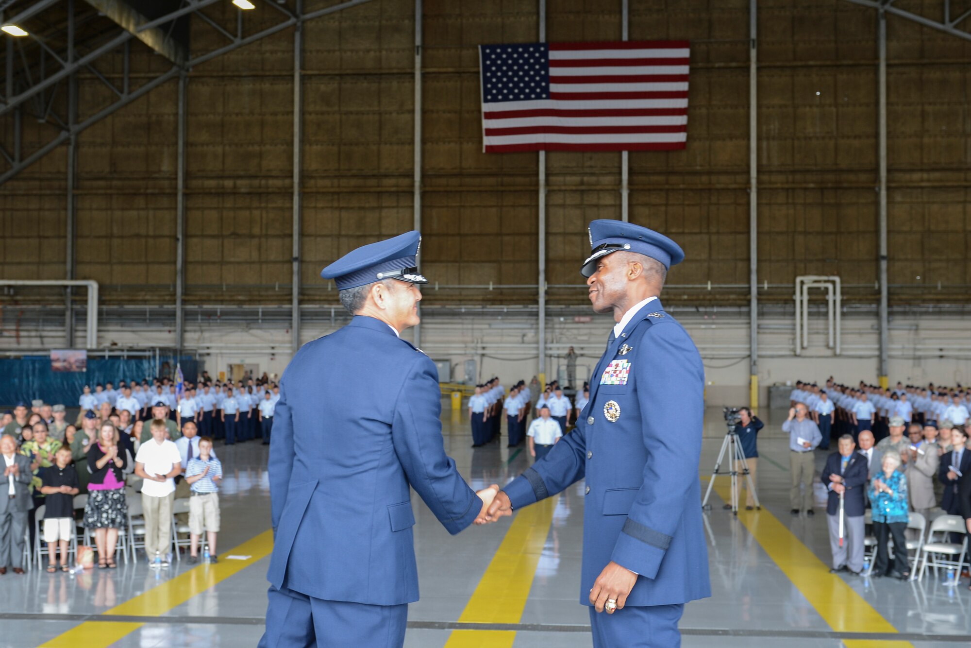 Lt. Gen. Darren McDew, 18th Air Force commander (right), congratulates Col. David Kumashiro, 62nd Airlift Wing commander, during the 62nd AW change of command ceremony July 17, 2013 at Joint Base Lewis-McChord, Wash. Kumashiro took command of the 62nd AW from Col. Wyn Elder. (U.S. Air Force photo/Staff Sgt. Frances Kriss)