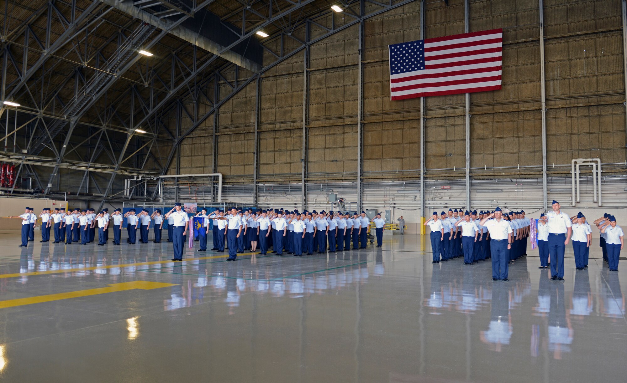 Airmen of the 62nd Airlift Wing salute during the 62nd AW change of command ceremony July 17, 2013 at Joint Base Lewis-McChord, Wash. Col. David Kumashiro took command of the 62nd AW from Col. Wyn Elder. (U.S. Air Force photo/Staff Sgt. Frances Kriss)