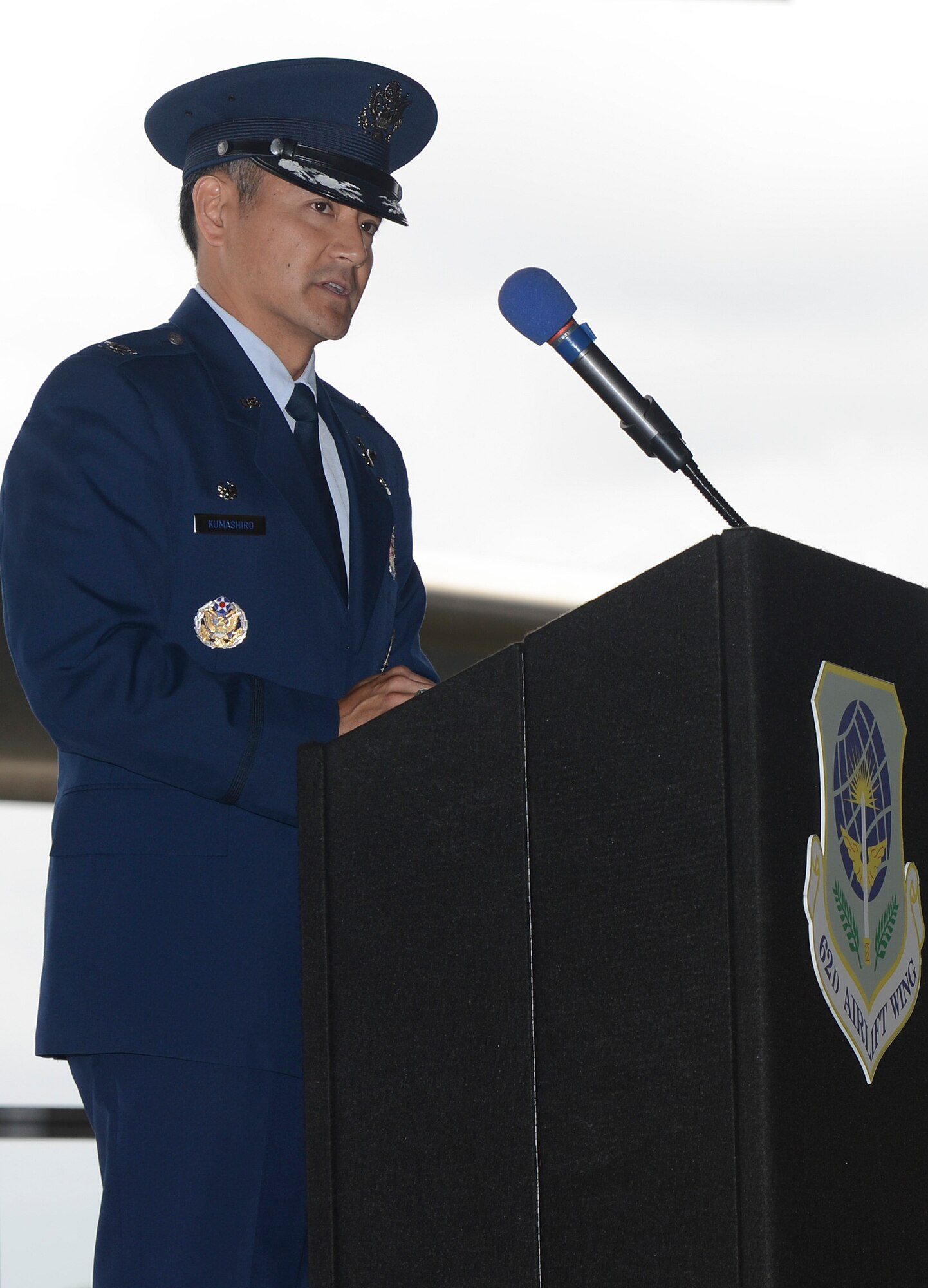 Col. David Kumashiro, 62nd Airlift Wing commander, addresses attendees of the 62nd AW change of command ceremony, July 17, 2013, at Joint Base Lewis-McChord, Wash. Kumashiro took command of the wing during a morning ceremony in Hangar 3 at McChord Field. (U.S. Air Force photo/Tech. Sgt. Sean Tobin)