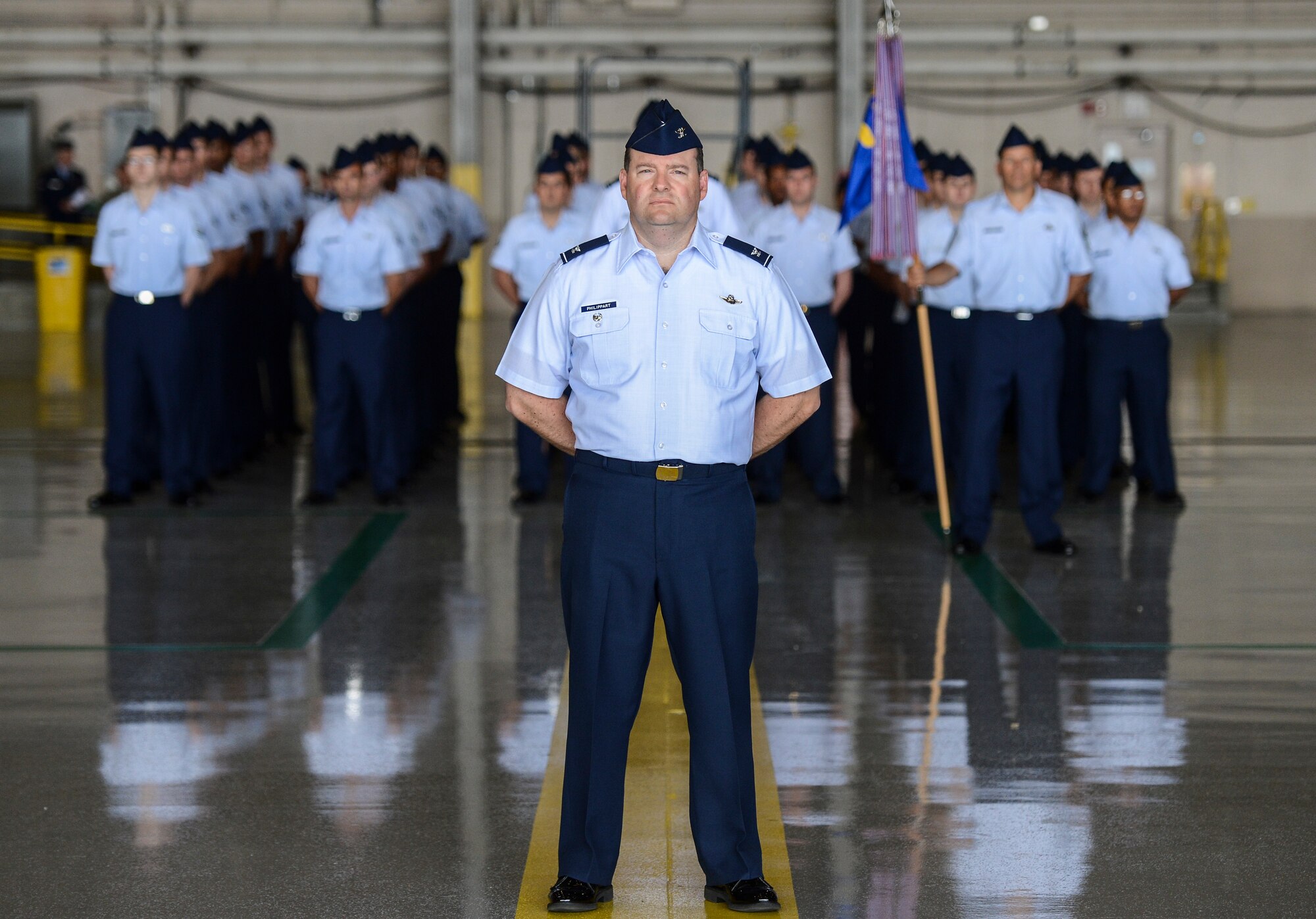 Col. Jeffrey Philippart, 62nd Airlift Wing vice commander, stands at the position of parade rest in front of a formation of 62nd AW Airmen during the wing change of command ceremony, July 17, 2013, at Joint Base Lewis-McChord, Wash. As the troop commander for the ceremony, Philippart was responsible for delivering commands to the Airmen in formation. (U.S. Air Force photo/Tech. Sgt. Sean Tobin) 