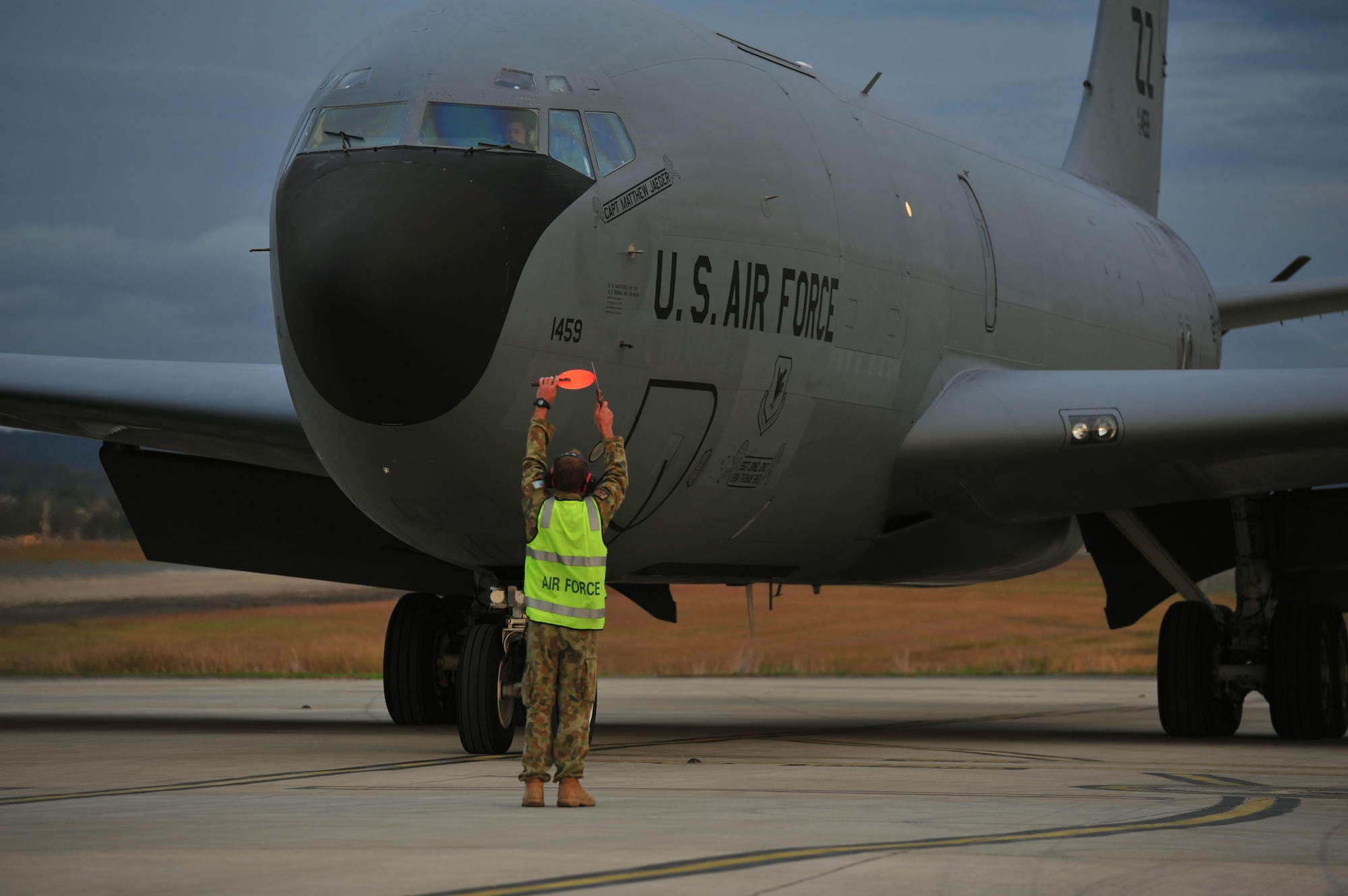 Royal Australian Air Force Leading Aircraftman Damien Deering, assigned to the No. 1 Airfield Operations Support Squadron, directs a U.S. Air Force KC-135 Stratotanker from Kadena Air Base, Japan, during taxi at Royal Australian Air Force Base Amberley, Australia, July 15, 2013. Two KC-135s arrived to provide aerial refueling during Talisman Saber 2013, a biennial training activity aimed at improving Australian Defence Force and U.S. combat readiness and interoperability as a combined joint task force. (U.S. Air Force photo by Staff Sgt. Rachelle Coleman/Released)