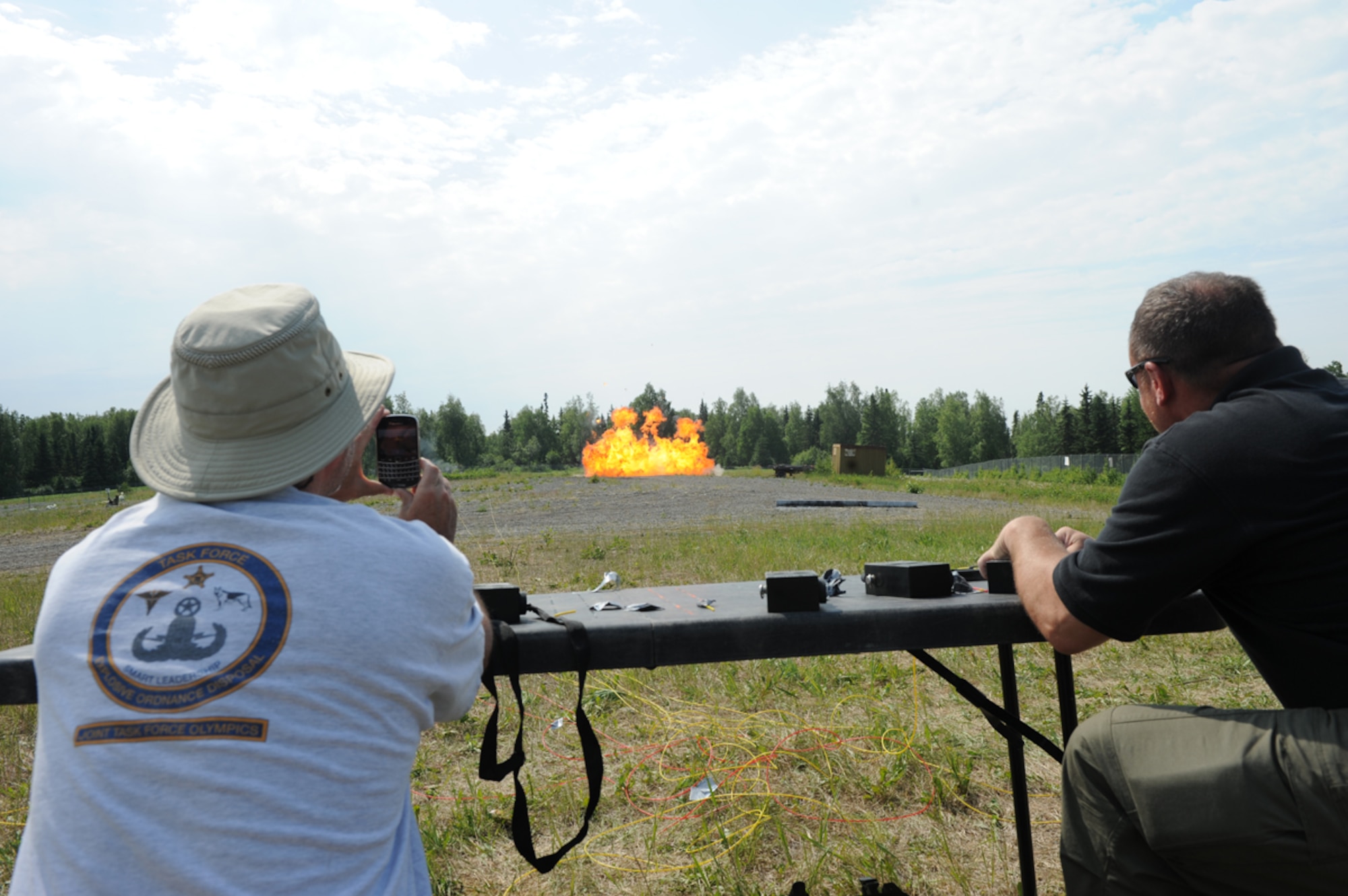 JOINT BASE ELMENDORF-RICHARDSON, Alaska -- Two special agents  of the FBI Anchorage Division, wire charges to ignite chemical improvised explosive devices, June 28.  The demonstration was part of Chemical Industry Outreach Workshop under the National Improvised Explosive Familiarization training program. (U.S. Air Force Photo/Airman 1st Class Omari Bernard)