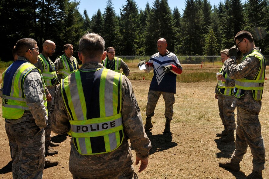 Master Sgt. Michael Pate (red, white, and blue instructor jersey), the 446th Security Forces Squadron NCO in charge of training, educates a group of security forces Reservists on all-terrain-vehicle basic riding and safety, July 14, 2013. Pate is also a certified ATV instructor. The ATV is one of the vehicles a security forces Airman might need in the field. For that reason, and because 446th SFS Reservists are deployable, they are required to take the ATV course every two to three years. Some of the 446th SFS Airmen have utilized those skills here at McChord Field to provide support for other security personnel, and incident response during major events, including air shows and Air Mobility Command Rodeo. (U.S. Air Force photo by Master Sgt. Jake Chappelle)