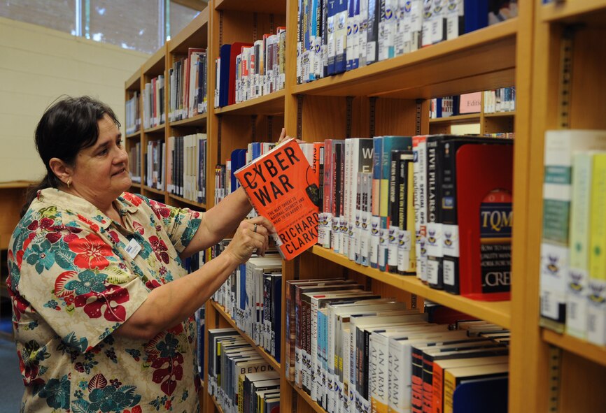 Fran Morris, 2nd Force Support Squadron library director, organizes books at the library on Barksdale Air Force Base, La., July 17, 2013. The library has every book listed on the Chief of Staff reading list dating back to its inception in 1997. (U.S. Air Force photo/Airman 1st Class Benjamin Gonsier)