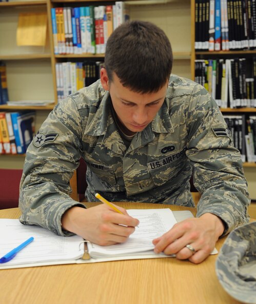 Airman 1st Class William Greenway, 2nd Maintenance Squadron, studies his career development course materials at the library on Barksdale Air Force Base, La., July 17, 2013. Greenway is a 2nd MXS Fabrication Flight Metal Technology apprentice studying for his 5-level. (U.S. Air Force photo/Airman 1st Class Benjamin Gonsier)
