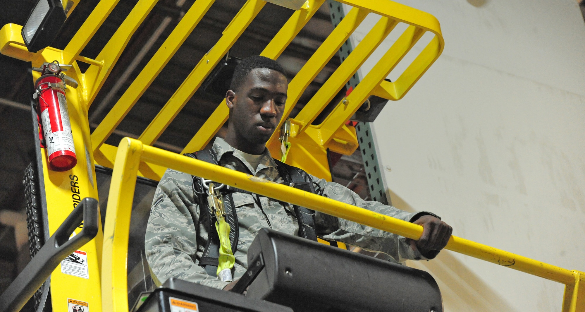 Airman 1st Class Terrell Grant, 509th Logistics Readiness Squadron central storage journeyman, uses a hyster to pull heavy equipment off of a shelf at the central storage warehouse at Whiteman Air Force Base, Mo., June 25, 2013. Hysters help Airmen lift equipment that weighs up to one ton. (U.S. Air Force photo by Staff Sgt. Nick Wilson/Released)