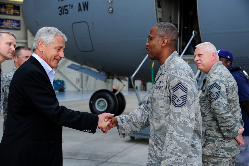 Secretary of Defense Chuck Hagel shakes hands with Chief Master Sgt. Rob Scarlett, 437th Aircraft Maintenance Squadron superintendent, during the Joint Base Charleston’s “Air Force showcase” July 17, 2013, at JB Charleston – Air Base, S.C. Hagel’s visit to JB Charleston included learning about flying and support operations conducted in the Air Force at Charleston, meeting with Boeing representatives to talk about what the company provides to the Air Force, and conducting a town hall meeting with Department of Defense civilian employees to discuss federal government sequestrations and civilian work furloughs in the department. (U.S. Air Force photo/Staff Sgt. Rasheen Douglas)