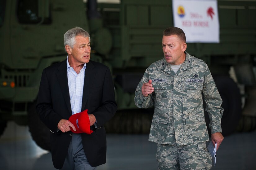 Secretary of Defense Chuck Hagel walks with Col. Richard McComb, Joint Base Charleston commander July 17, 2013, at Joint Base Charleston- Air Base, S.C. Hagel is the 24th Secretary of Defense and the first enlisted combat veteran to lead the Department of Defense. Hagel’s visit to JB Charleston included briefings on flying and support operations conducted by the Air Force in Charleston, meeting with Boeing representatives about the company’s involvement with the Air Force, and conducting a town hall meeting with Department of Defense civilian employees to discuss the federal government’s sequestration and civilian work furloughs.  (U.S. Air Force photo/ Senior Airman George Goslin)