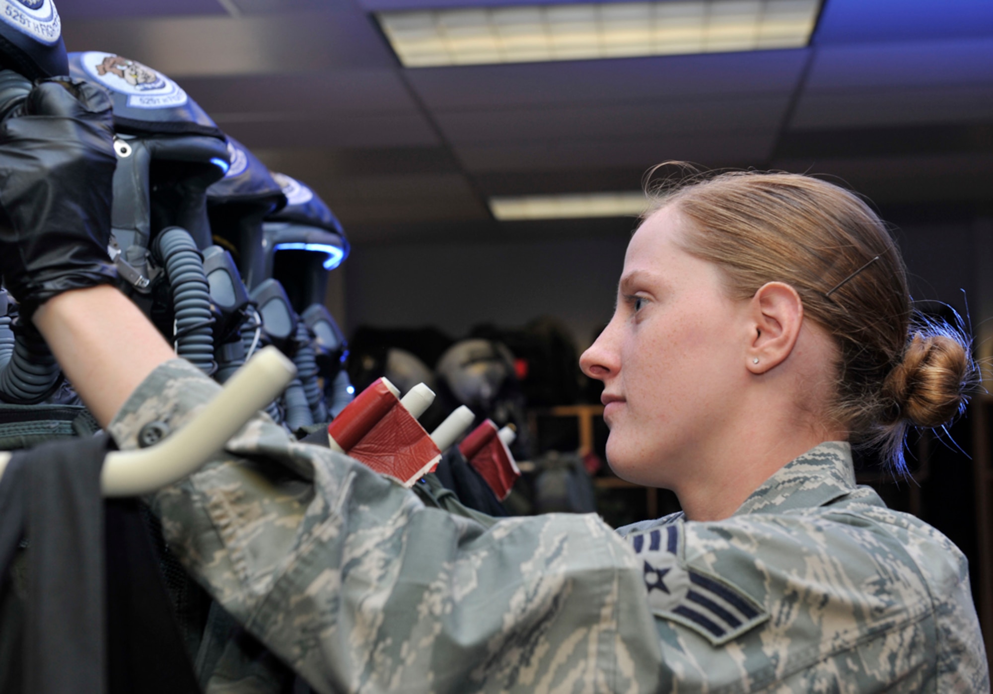 7/8/2013 - JOINT BASE ELMENDORF-RICHARDSON, Alaska-- Senior Airman Amanda Stinnett, 3rd Operation Support Squadron aircrew flight equipment journeyman, checks oxygen hoses for leaks at the 90th Fighter Squadron on Joint Base Elmendorf-Richardson July 8. As an AFE journeyman, Stinnett inspects and maintains equipment used by pilots. Stinnett won the Aircrew Flight Equipment Award in 2012, which recognizes outstanding accomplishments from Airman in the AFE career field. (U.S. Air Force photo/Airman 1st Class Tammie Ramsouer)