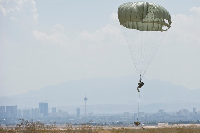 An Airman from the 820th RED HORSE Airborne Flight prepares to land during a training mission July 12, 2013, at Nellis Air Force Base, Nev. The 820th RED HORSE prepares Airmen for real-world missions by providing training exercises on rapid response airdrop and expedient airfield damage repairs to establish airfield contingency operations. (U.S. Air Force photo by Senior Airman Matthew Lancaster)