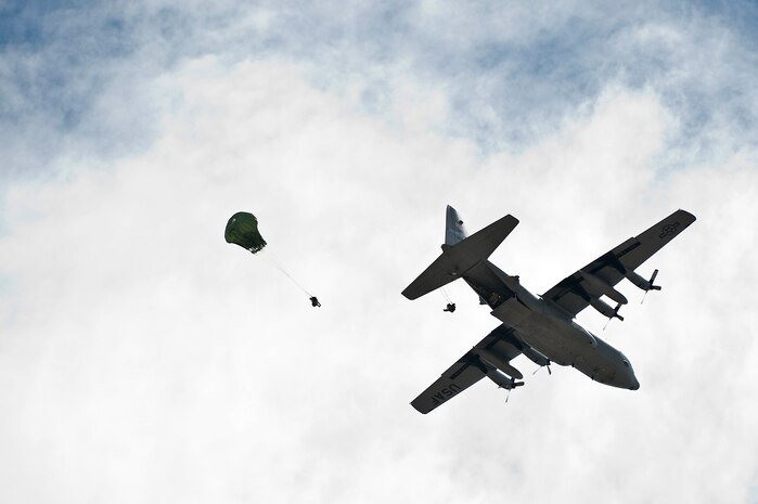 Airmen from the 820th RED HORSE Airborne Flight jump from a C-130 Hercules assigned to the 152nd Airlift Wing from the Nevada Air National Guard out of Reno, Nev., July 12, 2013, at Nellis Air Force Base, Nev. The 820th RED HORSE is the only Air Force civil engineer unit with airborne and air assault qualified engineer, explosive ordnance disposal, emergency management and fire/emergency services Airmen. (U.S. Air Force photo by Senior Airman Matthew Lancaster)