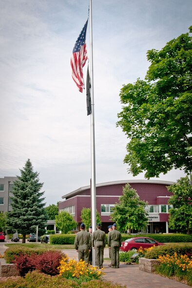 Members of the 96th Airlift Squadron lower the flag during retreat ceremony during the Unit Training Assembly weekend at the Minneapolis-St. Paul Air Reserve Station, Minn.  (U.S. Air Force photo/MSgt. Scott Farley)