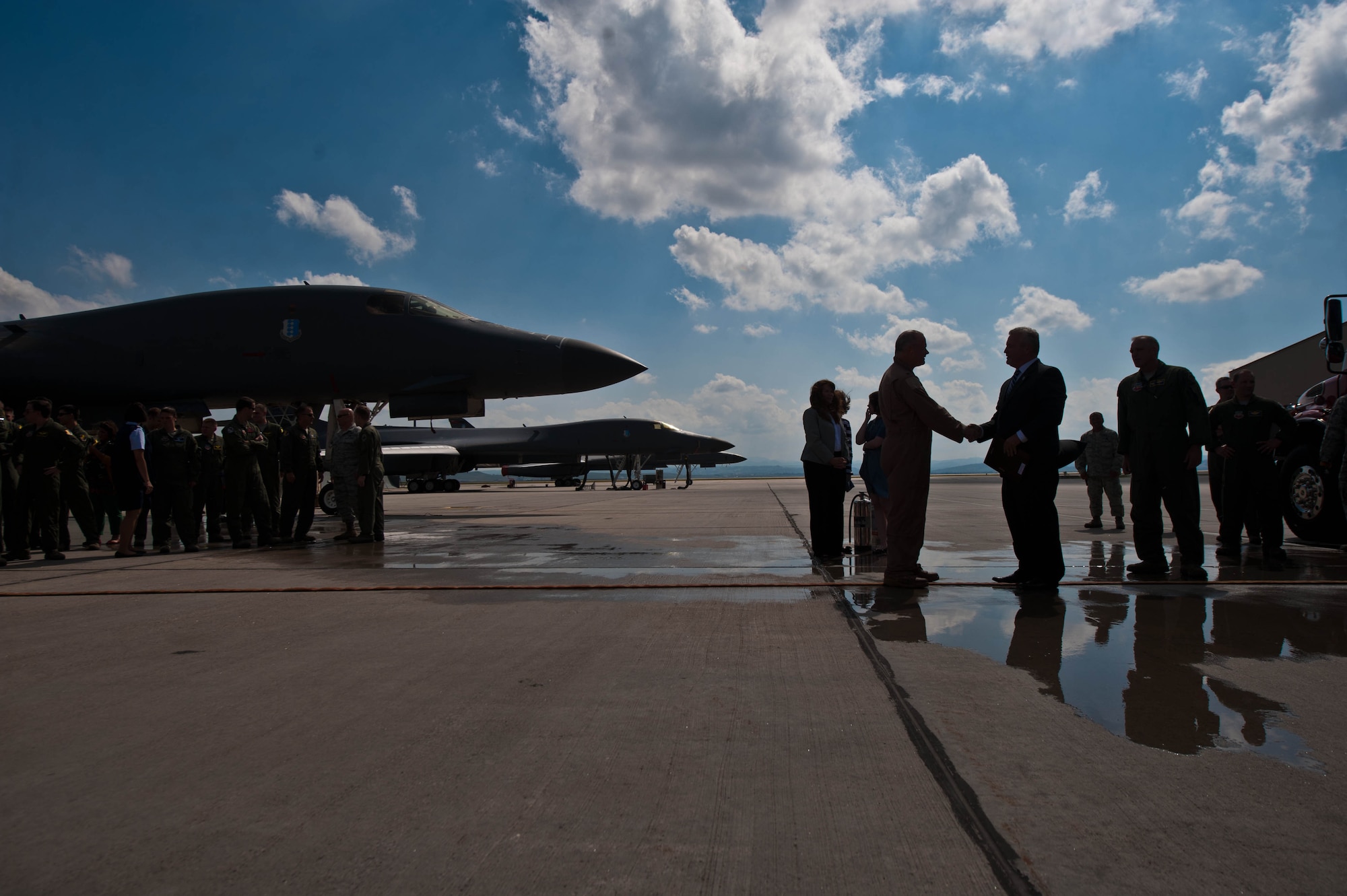 Dan Ruder, Boeing B-1 bomber advanced program manager, congratulates Lt. Col. Timothy Schepper, 28th Operations Group senior evaluator, after his record-breaking return flight from Southwest Asia by at Ellsworth Air Force Base, S.D., July 15, 2013. Schepper, who has flown more than 5,000 hours in the B-1, credits his family and fellow Airmen for helping him reach the milestone.(U.S. Air Force photo by Airman 1st Class Zachary Hada/Released)