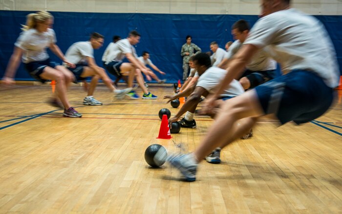 Airmen race to the middle of the court to grab foam balls during the Commanders Dodgeball Challenge July 12, 2013, at the Fitness Center at Joint Base Charleston - Air Base, S.C. The monthly Commanders Challenge is a Wing initiative intended to encourage resident interaction and camaraderie as part of Comprehensive Airman Fitness. (U.S. Air Force photo/Senior Airman Dennis Sloan)