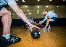 Airmen reach for a foam ball during the Commanders Dodgeball Challenge July 12, 2013, at the Fitness Center at Joint Base Charleston - Air Base, S.C. The monthly Commanders Challenge is a Wing initiative intended to encourage resident interaction and camaraderie as part of Comprehensive Airman Fitness. (U.S. Air Force photo/Senior Airman Dennis Sloan)