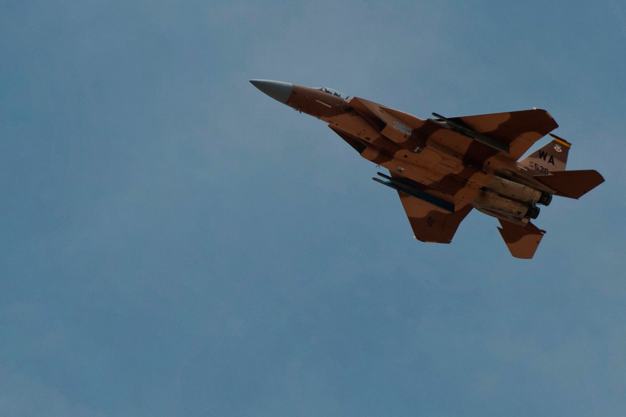 An F-15 Eagle from the 65th Aggressors Squadron, flies over the flight line after participating in training mission July 16, 2013, at Nellis Air Force Base, Nev. With the resumption of flight operations, the 64th and 65th Aggressors, as well as the 422nd Test and Evaluation Squadron, will resume their support of air combat training and operational testing.  (U.S. Air Force photo by Senior Airman Daniel Hughes)