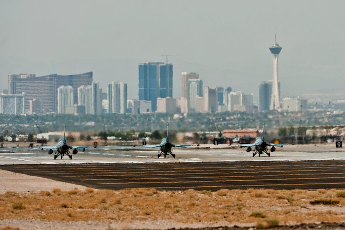 Three F-16 Falcons, assigned to the 64th Aggressors Squadron, prepare to take off for a training mission July 16, 2013, at Nellis Air Force Base, Nev. The restoration of flying operations represents a Congressional action which gave the Air Force approval to use $423 million to restore flying hours for affected units.  (U.S. Air Force photo by Senior Airman Daniel Hughes)