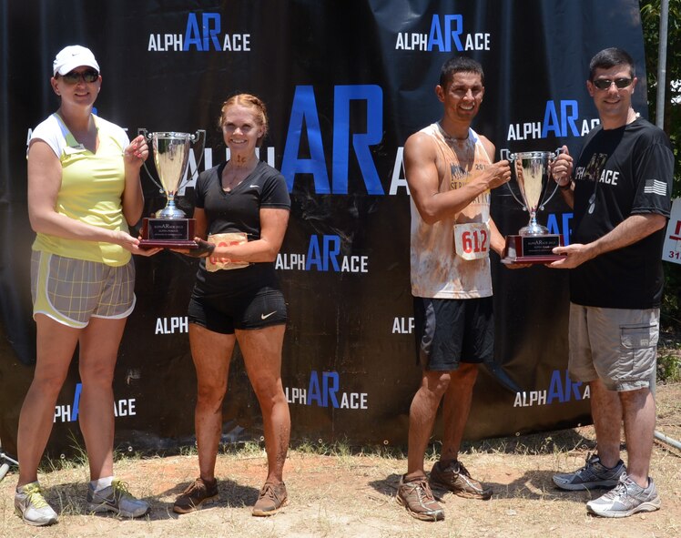 Lt. Col. Diane Benavidez, 2nd Force Support Squadron commander, far left, and Col. Andrew Gebara, 2nd Bomb Wing commander, far right, pose with the winners from the alphARace at the East Reservation on Barksdale Air Force Base, July 13, 2013. 2nd Lt. Brittany Hicks, 2nd FSS, won the final championship race in 48:02.9 while Senior Master Sgt. Randall Kingfisher, Air Force Global Strike Command, won the final wave in 34:25.8. Both Airmen ran the previous night and finished in the top three of their respective waves to qualify for the championship race. (U.S. Air Force photo/Staff Sgt. Amber Corcoran)
