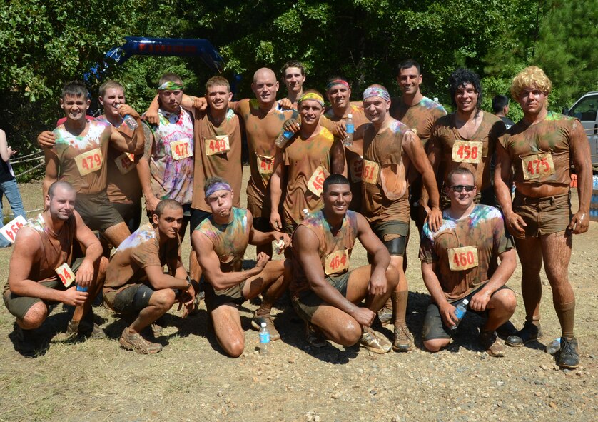 Airmen from the 2nd Maintenance Squadron pose for a photo after their wave during the alphARace at the East Reservation on Barksdale Air Force Base, La., July 13, 2013. More than 600 members of Team Barksdale and the local community took on the 4.2 miles of woods, mud and obstacles. The top three males and females from each wave both days of the race, qualified for the final championship to win the alphARace trophies. (U.S. Air Force photo/Staff Sgt. Amber Corcoran)