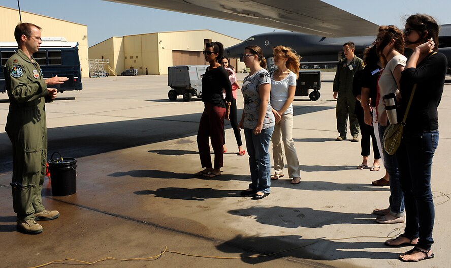 Maj. Nathan Loucks, 28th Operations Support Squadron chief of wing scheduling, gives spouses of Ellsworth Airmen a brief introduction to the B-1 bomber airframe during a Heartlink orientation on the flightline at Ellsworth Air Force Base, S.D., July 15, 2013. Elements of the quarterly program include presentations from 28th Bomb Wing leadership, the 28th BW Protocol Office, the 28th Medical and Mission Support Groups, along with a tour of a B-1 static display. (U.S. Air Force photo by Airman 1st Class Ashley J. Thum/Released) 