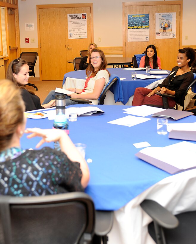 Spouses of Ellsworth Airmen interact with key spouses during a Heartlink orientation in the Rushmore Center at Ellsworth Air Force Base, S.D., July 15, 2013. Heartlink is a program headed by the wing commander and hosted by the Airman and Family Readiness Center designed to educate and update spouses on the abilities, resources available and mission at Ellsworth. (U.S. Air Force photo by Airman 1st Class Ashley J. Thum/Released)