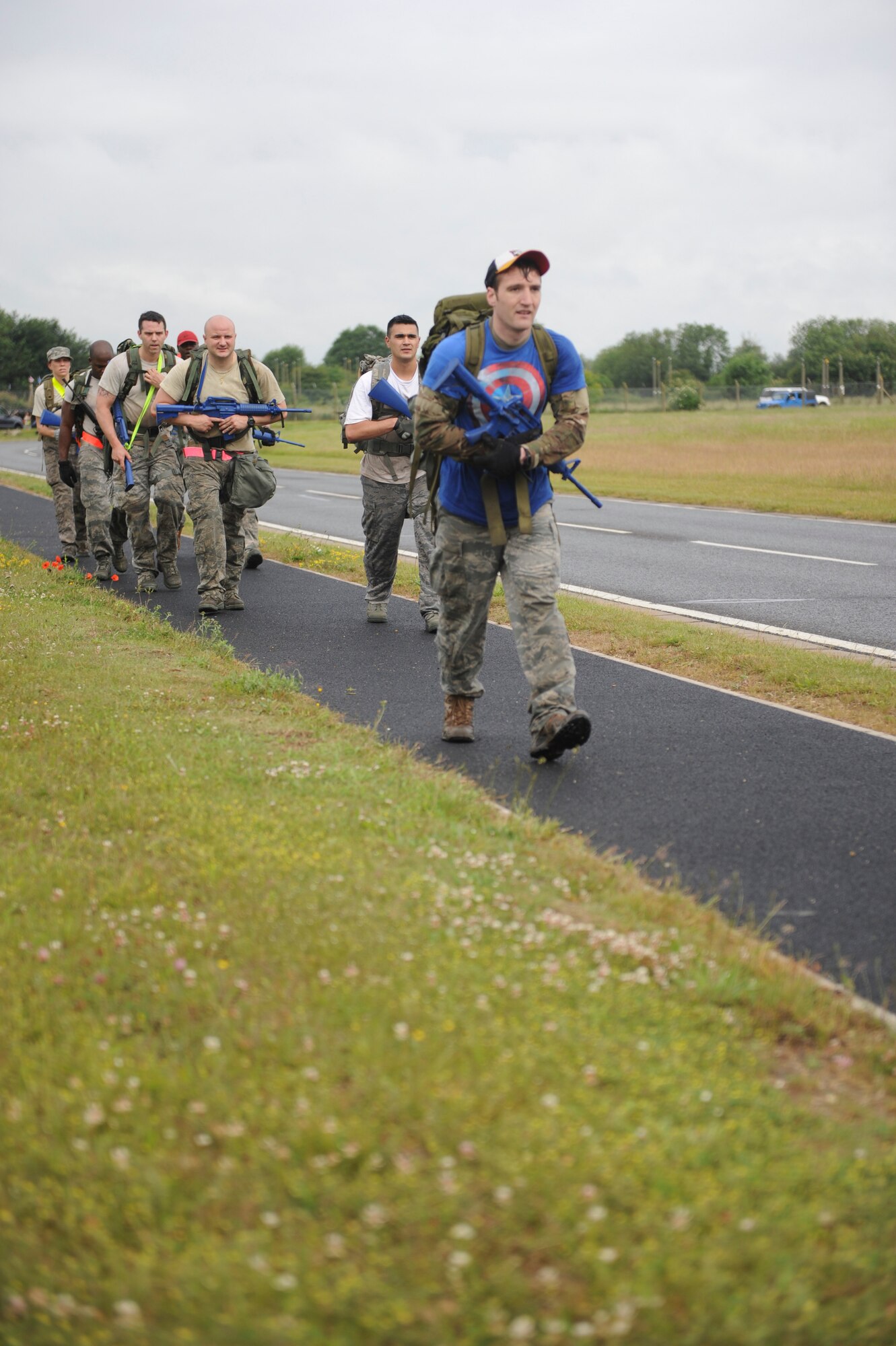 Monster Mash team members march with 40-pound rucksacks July 3, 2013, during the 352nd Special Operations Group Olympics on RAF Mildenhall, England. The Monster Mash consisted of various events such as carrying a Zodiac inflatable boat just under a mile and marching with a 40-pound rucksack for 1.5 miles. “Nothing brings a group of individuals together like enduring a little bit of suck. It builds teamwork,” said Chief Master Sgt. William Markham, 352nd SOG command chief. (U.S. Air Force photo by Airman 1st Class Preston Webb/Released)