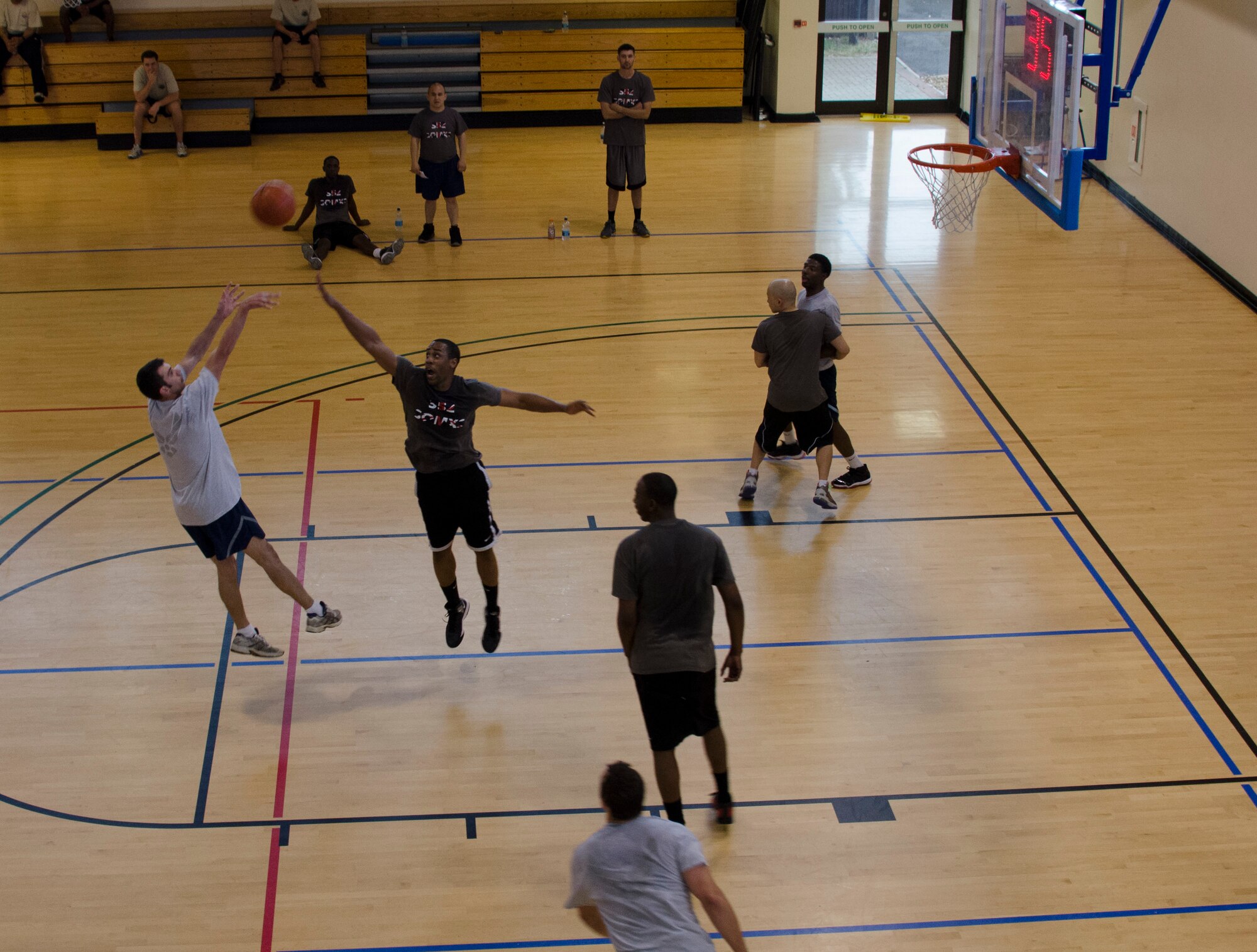 From left, a 352nd Special Operations Support Squadron member shoots the ball July 3, 2013, during a game between the 352nd SOSS and the 352nd Special Operations Maintenance Squadron at the Hardstand Fitness Center on RAF Mildenhall, England. Basketball was one of eight events in the 352nd Special Operations Group Olympics. (U.S. Air Force photo by Staff Sgt. Stephen Linch/Released)