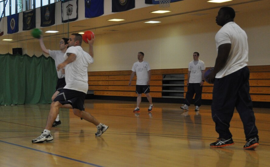 Team Mildenhall members play dodgeball July 3, 2013, during the 352nd Special Operations Group Olympics on RAF Mildenhall, England. The 352nd SOG Olympics consisted of ultimate rugby, basketball, dodgeball, Monster Mash and other competitions. The 352nd SOG Olympics is designed to foster teamwork and unity of action among approximately 1,000 members of the 352nd SOG. (U.S. Air Force photo by Capt. Jason Smith/Released)