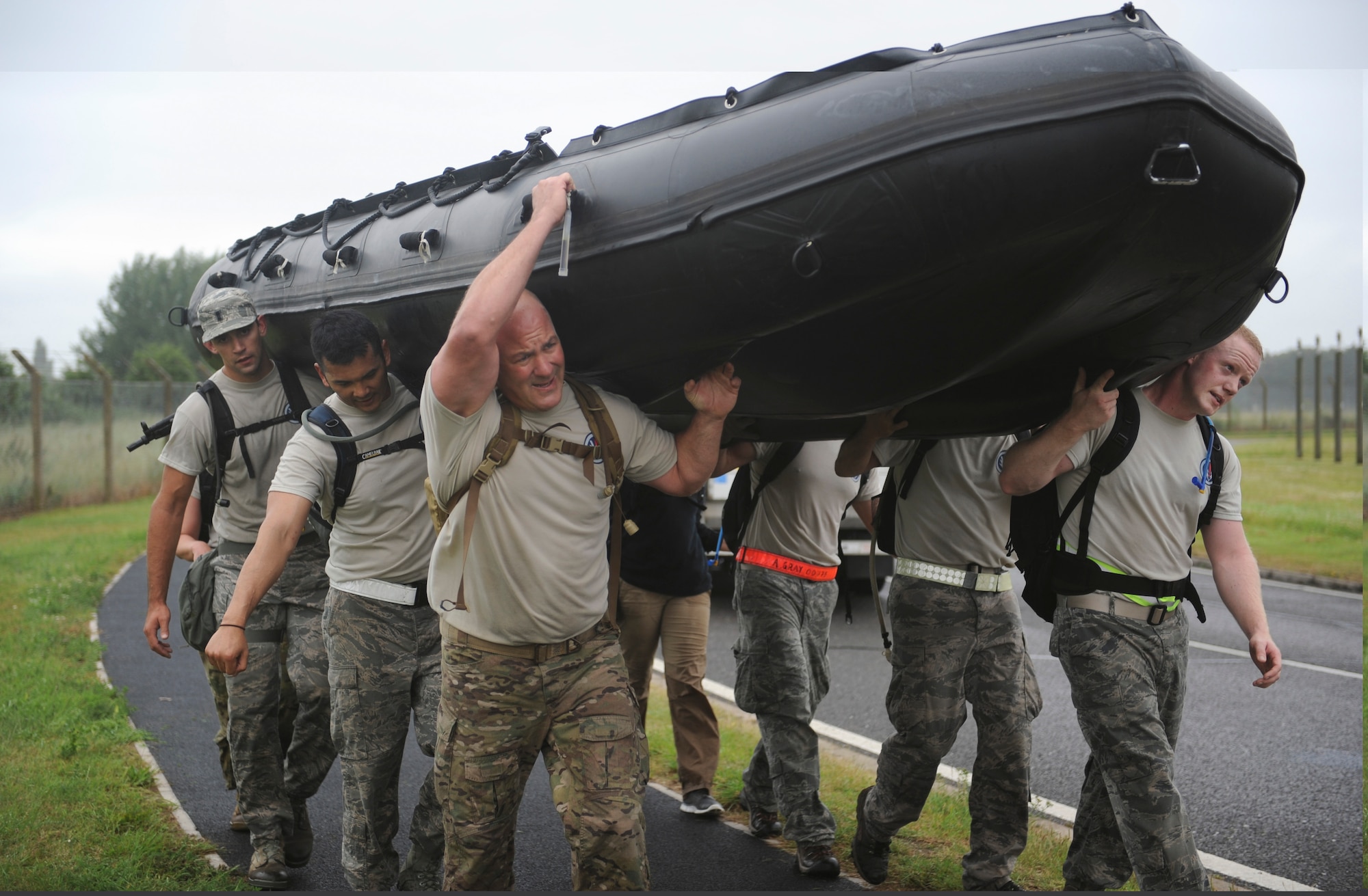 A Monster Mash team carries a Zodiac inflatable boat July 3, 2013, during the 352nd Special Operations Group Olympics on RAF Mildenhall, England. While the 321 Special Tactics Squadron team won the Monster Mash event, the 352nd Special Operations Maintenance Squadron won the 352nd SOG Olympics and was awarded the “SOG Hog.” (U.S. Air Force photo by Airman 1st Class Preston Webb/Released) 