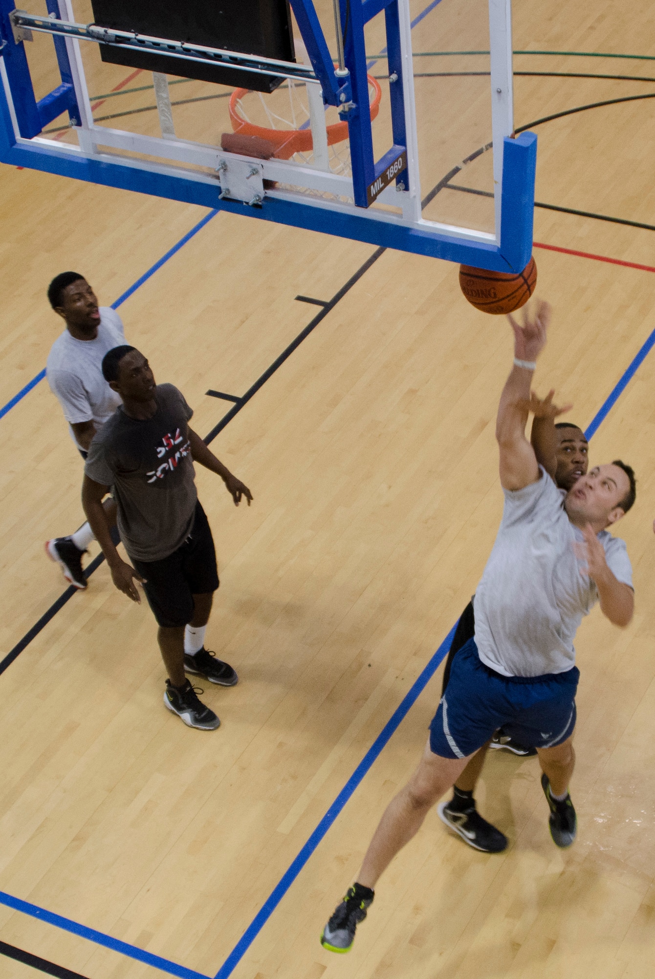A 352nd Special Operations Support Squadron member shoots the ball during a game between the 352nd SOSS and the 352nd Special Operations Maintenance Squadron July 3, 2013, at the Hardstand Fitness Center on RAF Mildenhall, England. Basketball was one of eight events in the 352nd Special Operations Group Olympics. (U.S. Air Force photo by Staff Sgt. Stephen Linch/Released)