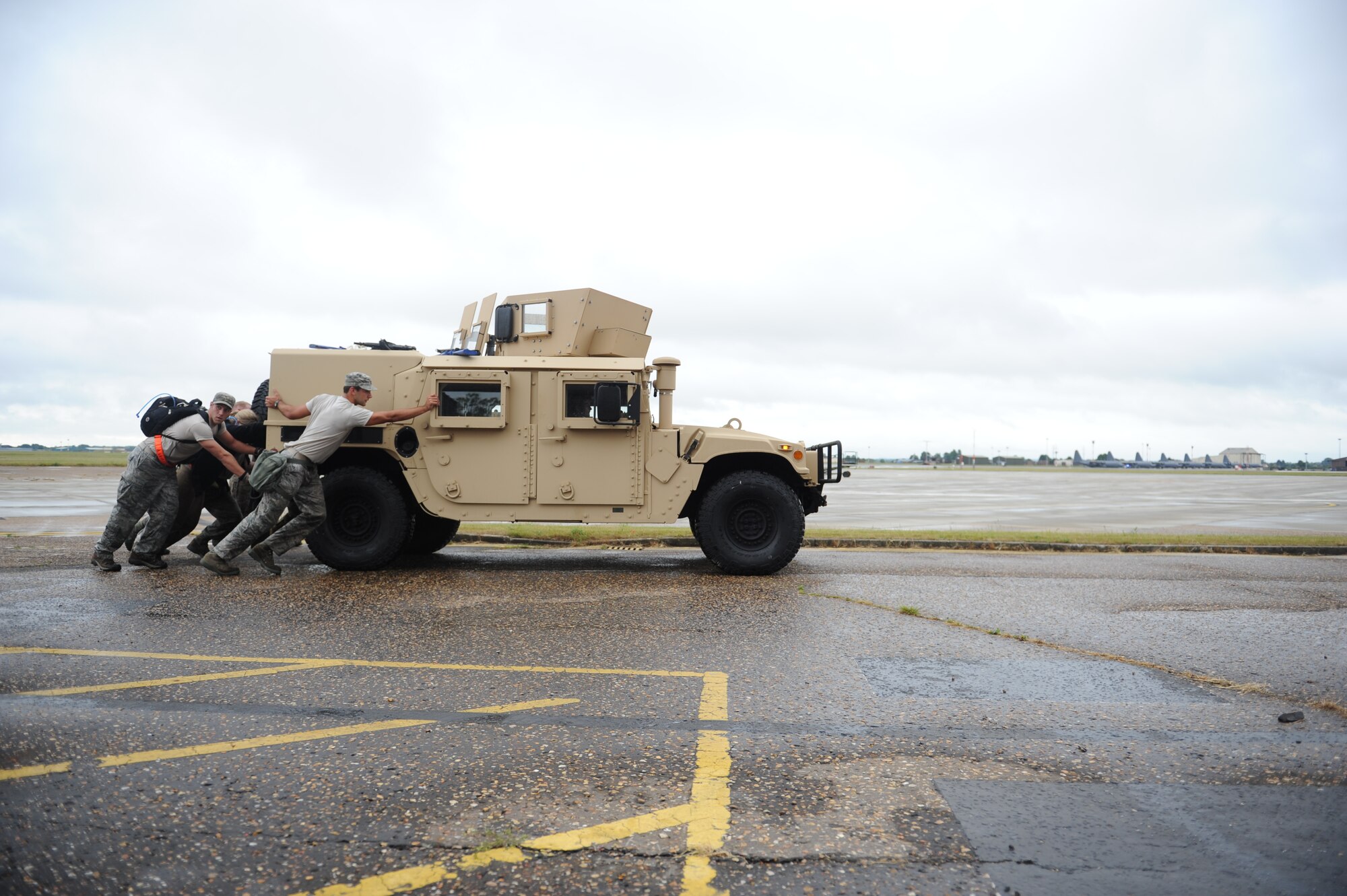 A Monster Mash team pushes a Humvee July 3, 2013, during the 352nd Special Operations Group Olympics on RAF Mildenhall, England. The 352nd SOG Olympics consisted of ultimate rugby, basketball, dodgeball, the Monster Mash and other competitions. The 352nd SOG Olympics is designed to foster teamwork and unity of action among approximately 1,000 members of the 352nd SOG. (U.S. Air Force photo by Airman 1st Class Preston Webb/Released)