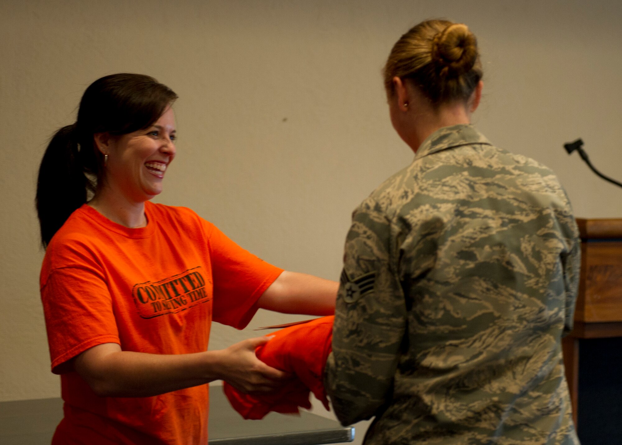 Amanda Gallagher, 49th Force Support Squadron marketing director, hands a team member her teams’ Big Give t-shirts and information packets during the Big Give season six kick-off at Holloman Air Force Base, N.M., July 12. This year’s Big Give theme is “Committed to Serving Time.” (U.S. Air Force photo by Senior Airman Kasey Close/Released)
