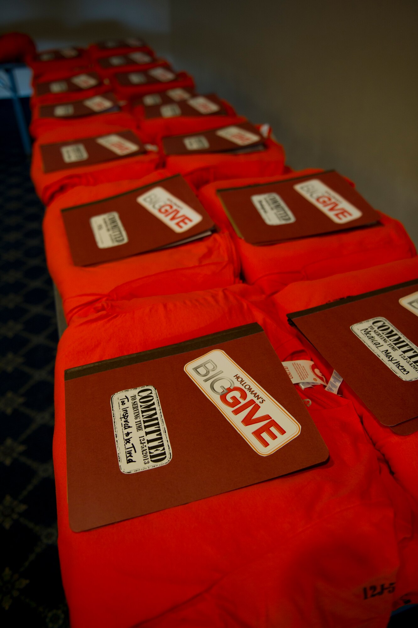 Team Holloman’s Big Give t-shirts and information packets await pick-up by team members during the Big Give season six kick-off at Holloman Air Force Base, N.M., July 12. This year Holloman has 26 teams participating in the event, making it the biggest yet. (U.S. Air Force photo by Senior Airman Kasey Close/Released)
