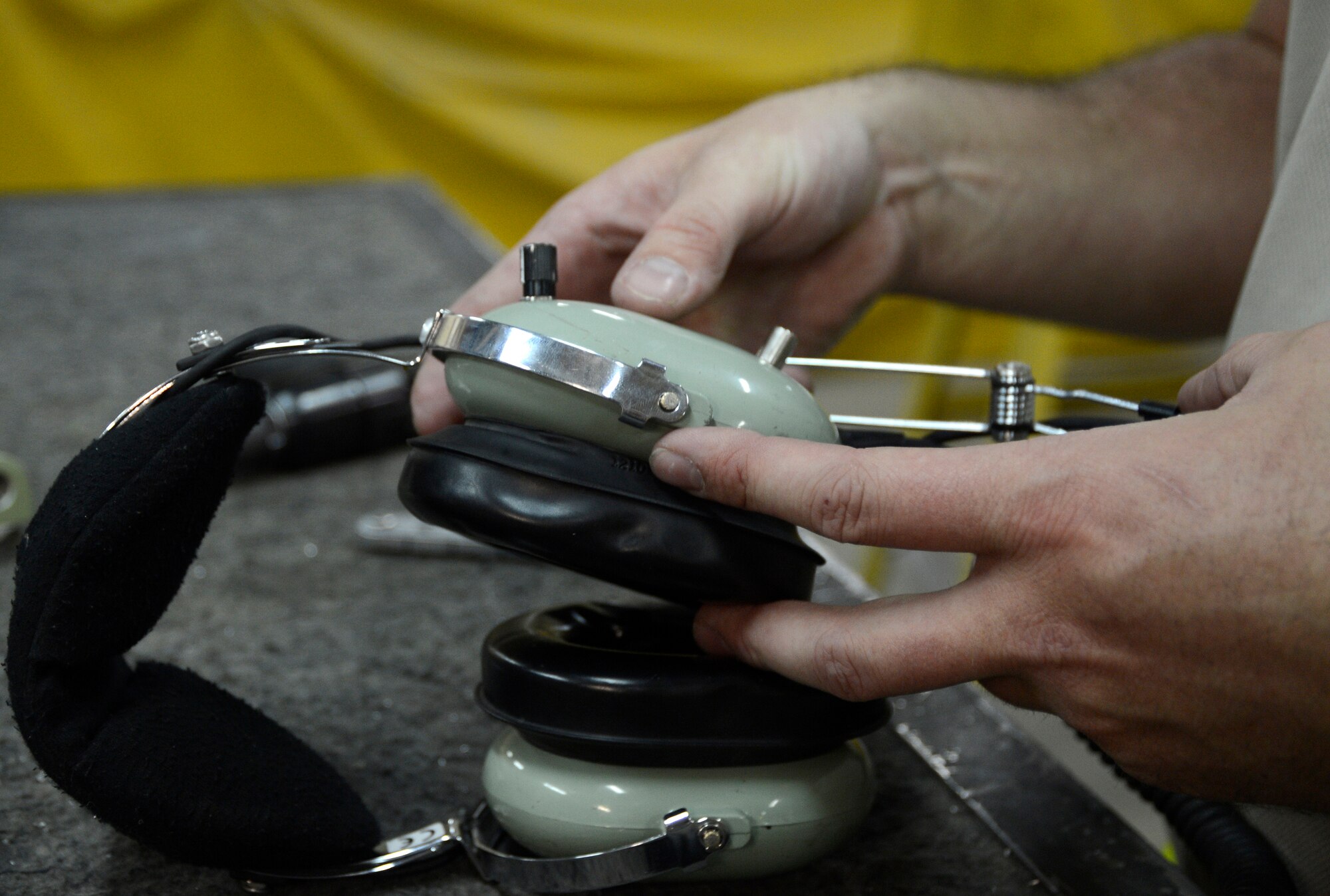 Staff. Sgt. Daniel Clemons, 386th Expeditionary Maintenance Squadron, fixes a crew chiefs headset here, July 11, 2013. Clemons, a member of the combat metals shop, used a nominal button head cherymax rivet on a $150 headset restoring it to a working asset. Clemons is deployed from the 19th Airlift Wing, Little Rock Air Force Base, Ark. (U.S. Air Force photo by Master Sgt. Christopher A. Campbell)