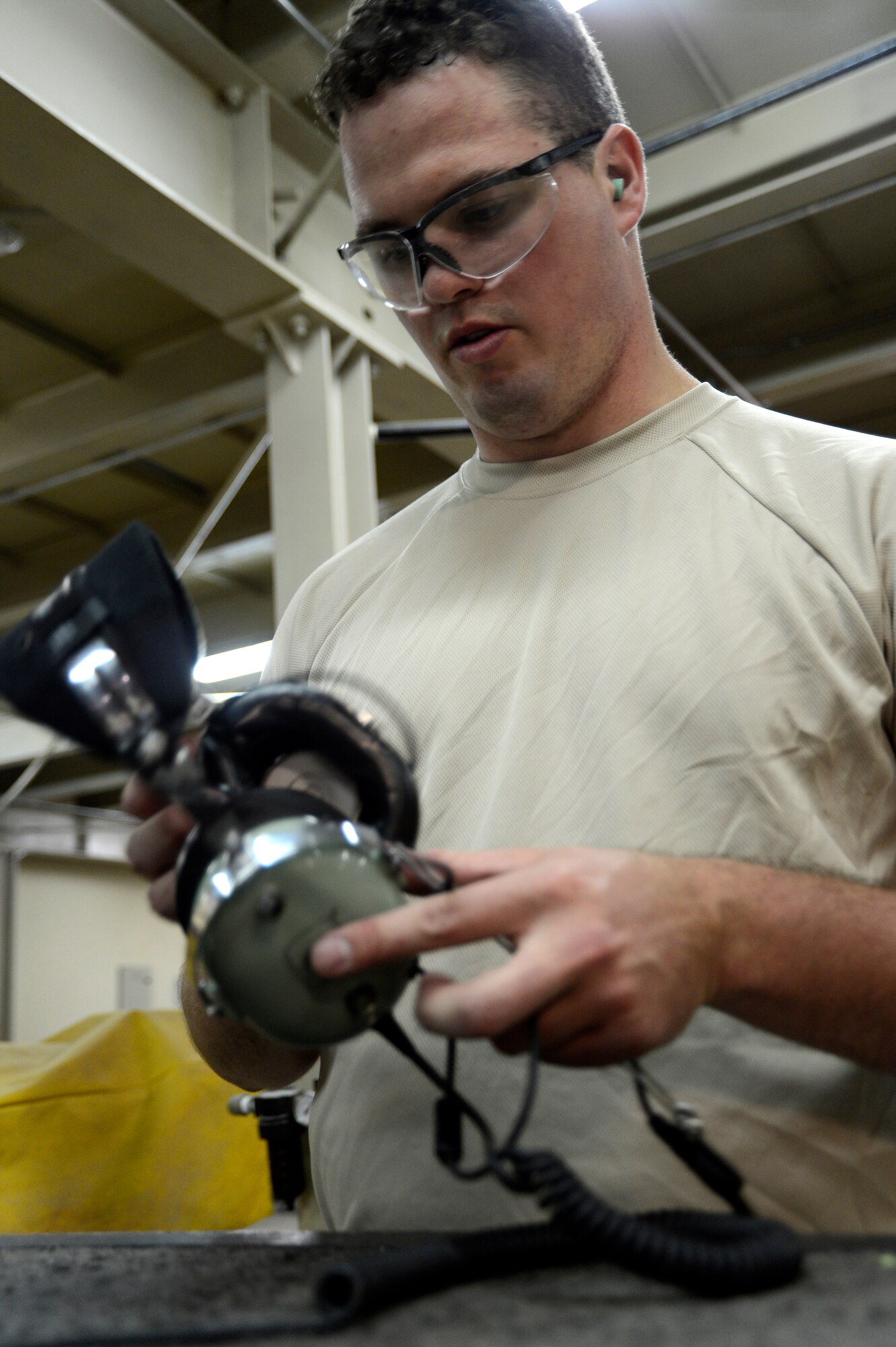 Staff. Sgt. Daniel Clemons, 386th Expeditionary Maintenance Squadron, fixes a crew chiefs headset here, July 11, 2013. Clemons is a member of the combat metals shop and his work on this headset saved the Air Force $150. Clemons is deployed from the 19th Airlift Wing, Little Rock Air Force Base, Ark. (U.S. Air Force photo by Master Sgt. Christopher A. Campbell)