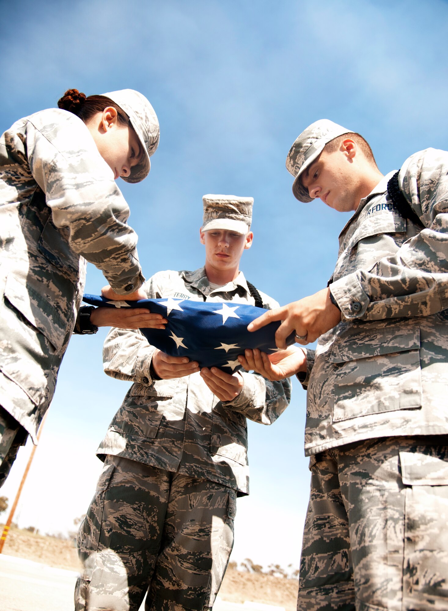 Airman Erica Howard, Airman Nicholas Terry and Airman 1st Class Stephen Lolici accomplishing retreat Friday, 31 May, 2013 at the 344th Training Squadron, DET1, schoolhouse at Port Hueneme, Calif. Black rope duties include flag detail, marching and calling cadence.
