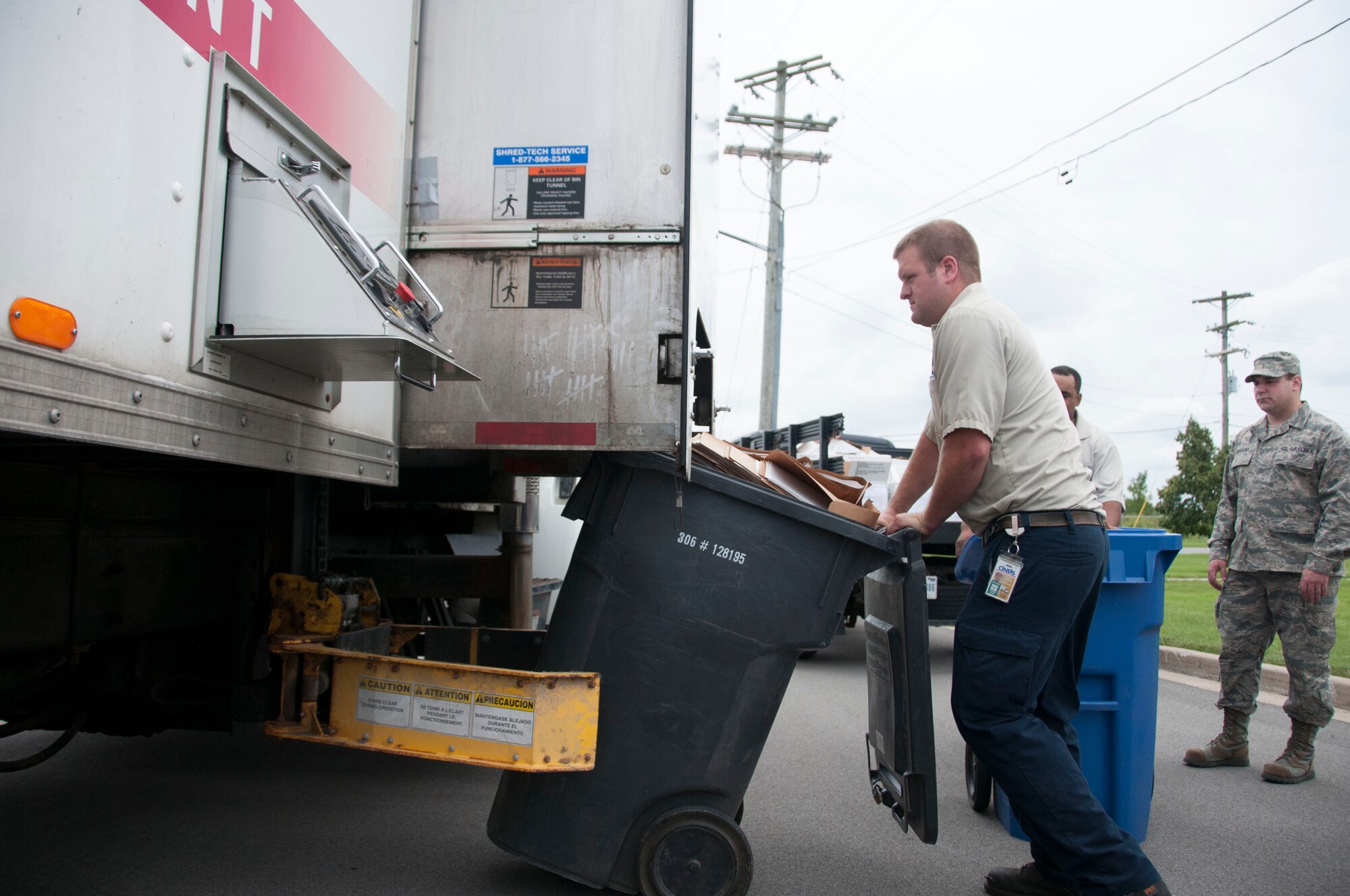A civilian worker loads a recycle bin full of personally identifiable information on a truck specially designed to destroy PII, at the Niagara Falls Air Reserve Station, July 14. The wing trains and protects military members and Department of Defense civilians alike in avoiding the release of personally identifiable information about themselves or others. (U.S. Air Force photo by Tech. Sgt. Andrew Caya)
