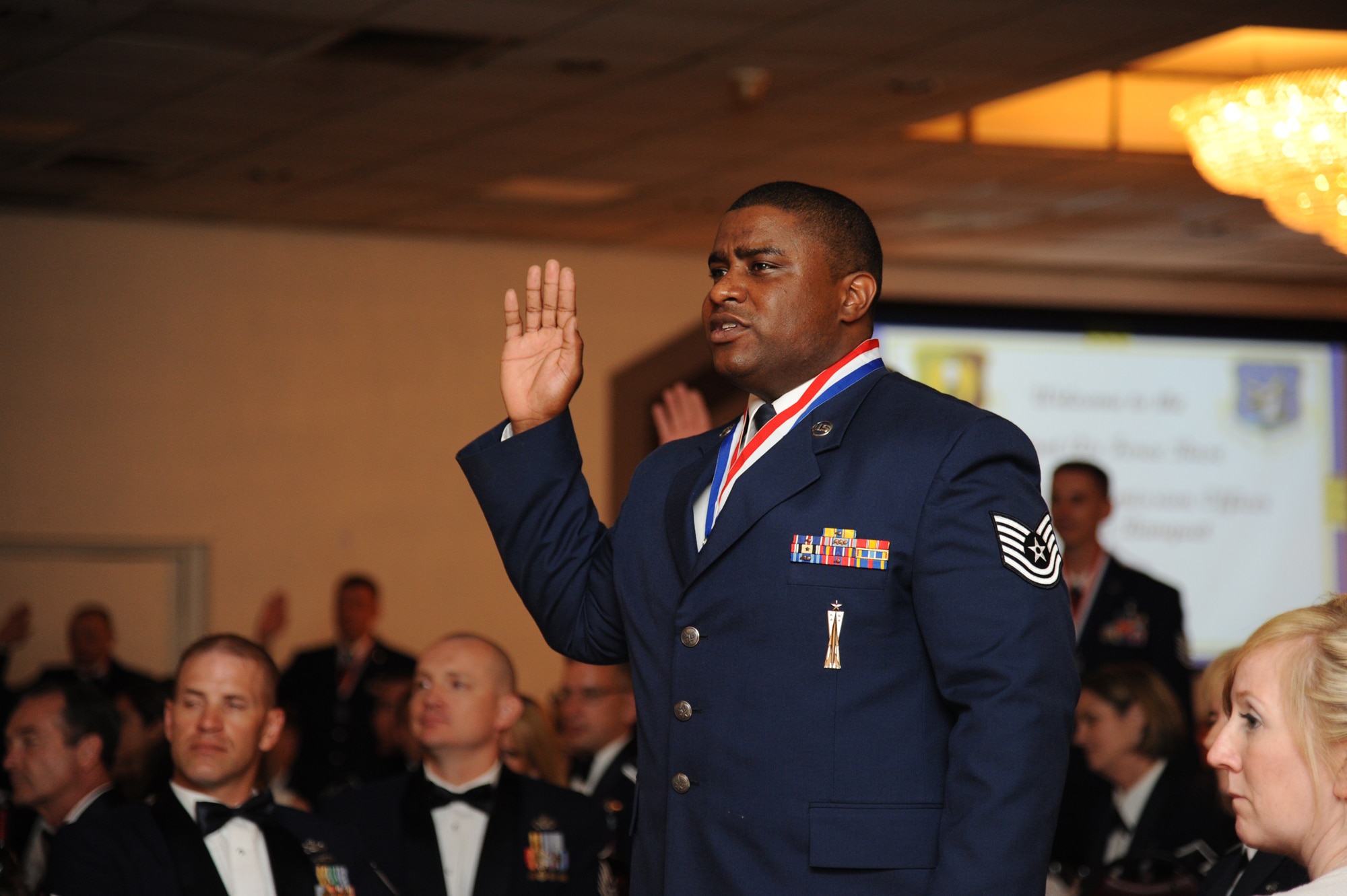 One of Minot Air Force Base’s newest senior noncommissioned officer inductee Tech. Sgt. Trulyn Williams, 91st Missile Operations Squadron, recites an oath during the SNCO Induction Ceremony at the Vegas Motel in Minot, N.D., July 12, 2013.  Chief Master Sgt. of the Air Force James Cody was the guest speaker for the event and spoke to the group of 49 master sergeant selects about the importance of their responsibilities and the select company they are now a part of. The ceremony was held to recognize individuals who progress through the ranks and have been selected for master sergeant promotion, transitioning them to senior leadership level with more responsibility. (U.S. Air Force photo/Airman 1st Class Andrew Crawford)