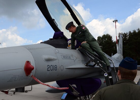 LASK AIR BASE, Poland -- Polish Air Force Commander Lt. Gen. Lech Majewski inspects the cockpit of a U.S. Air Force F-16 Fighting Falcon fighter aircraft July 17, 2013. Poland has employed the F-16 since 2006, and the tactics differ from U.S. pilots. The object of this two-week training course is to better integrate air capabilities and strengthen peace within the region. (U.S. Air Force photo by Staff Sgt. Daryl Knee/Released)