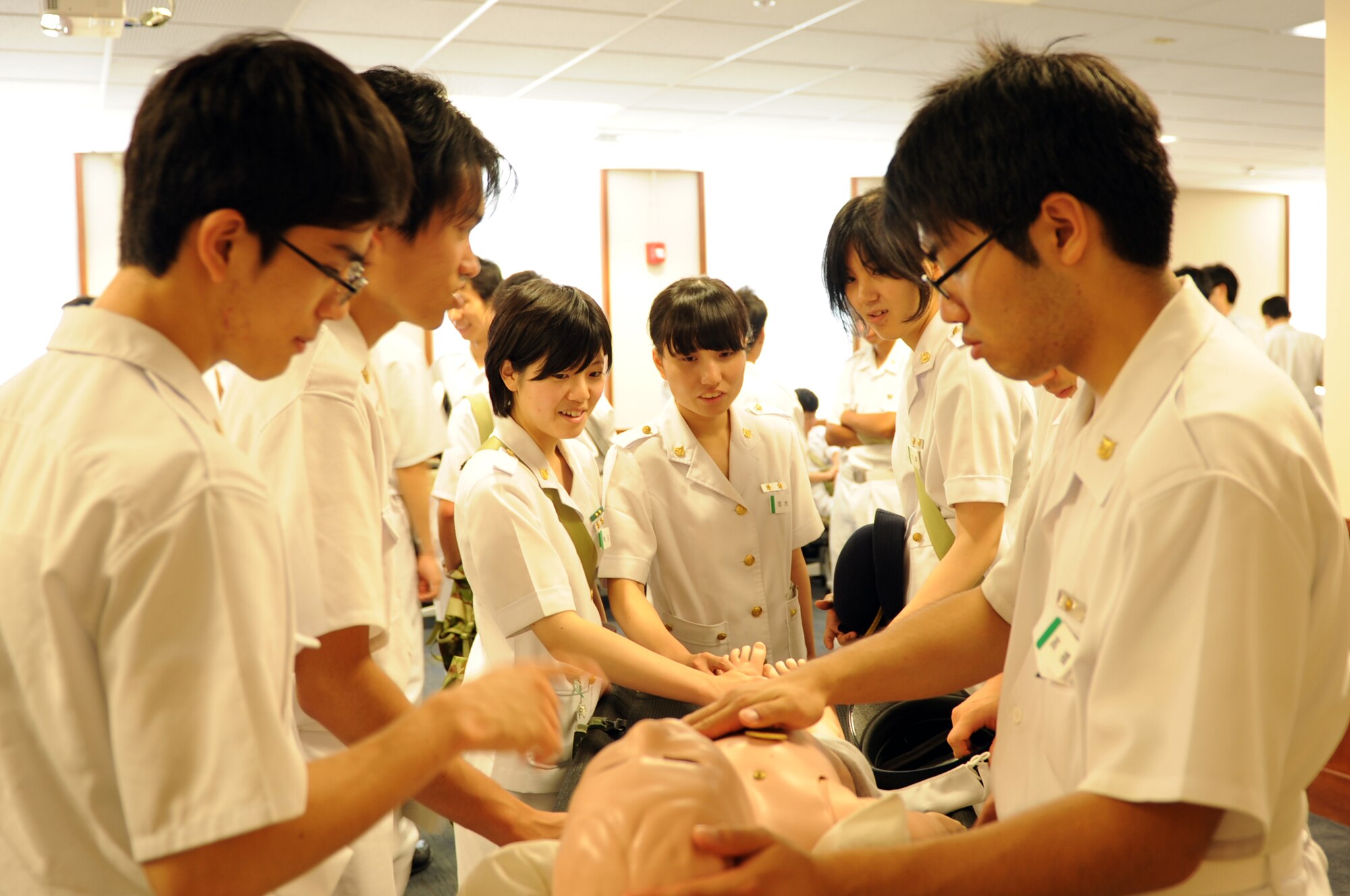 YOKOTA AIR BASE, Japan -- Third-year medical students from the National Defense Medical College examine a pediatric mannequin used by the 374th Medical Group for training July 11, 2013, during a visit at Yokota Air Base, Japan. In addition to looking at the training mannequins, the students toured the 374 MDG during their visit. (U.S. Air Force photo by Senior Airman Desiree Economides)