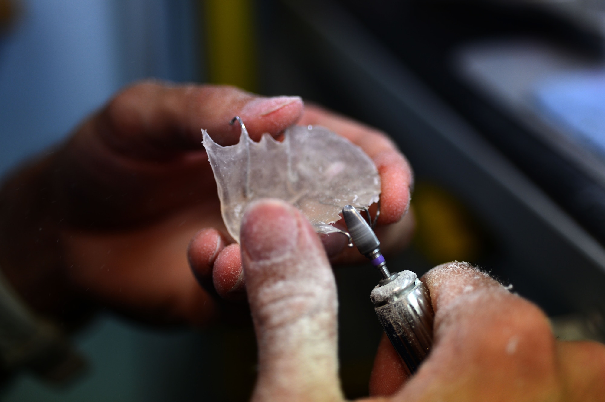 SPANGDAHLEM AIR BASE, Germany – U.S. Air Force Staff Sgt. Cory La Salle, 52nd Dental Squadron dental laboratory technician from Memphis, Tenn., grinds a retainer July 16, 2013. The grinding and smoothing of the plastic on the retainer is done to ensure an overall better and comfortable fit for the patient. (U.S. Air Force photo by Airman 1st Class Gustavo Castillo/Released)  