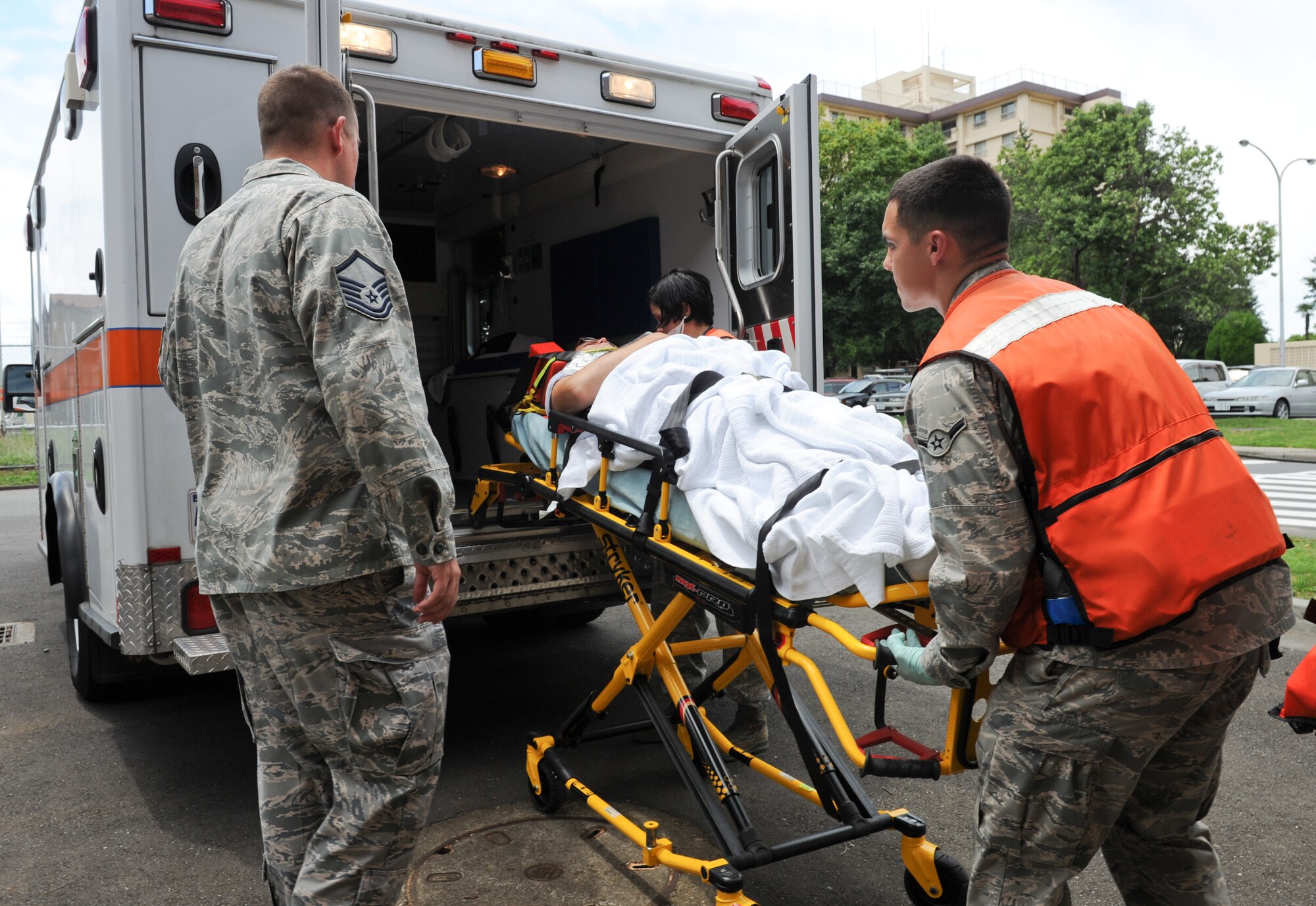 YOKOTA AIR BASE, Japan -- Members from the 374th Medical Group load a simulated victim into an ambulance during a medical exercise scenario at Yokota Air Base, Japan, July 15, 2013.  The 374th MDG provided care for patients in response to a simulated medical emergency scenario. (U.S. Air Force photo by Senior Airman Andrea Salazar/Released)