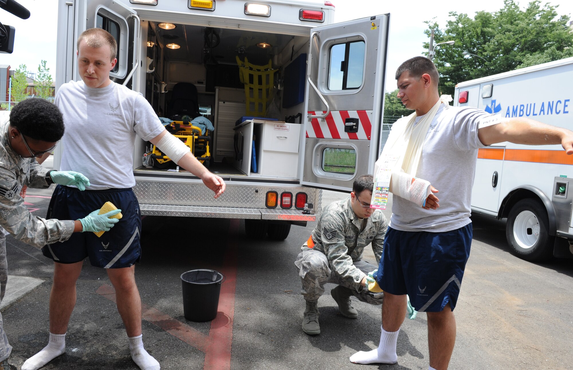 YOKOTA AIR BASE, Japan -- Members from the 374th Medical Group practice decontamination procedures on simulated victims during a medical decontamination exercise scenario at Yokota Air Base, Japan, July 15, 2013. The 374th MDG provided care for patients in response to a simulated medical emergency scenario. (U.S. Air Force photo by Senior Airman Andrea Salazar/Released)