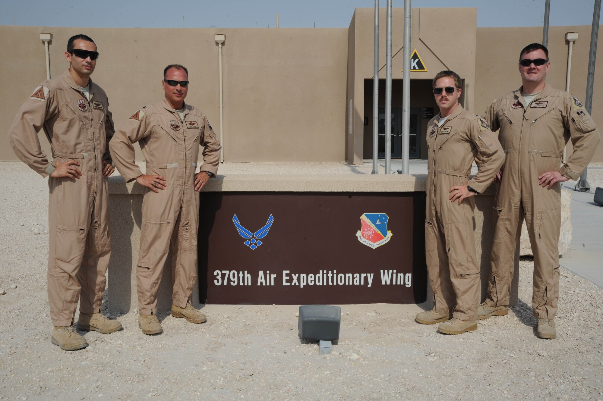 Members of the 379th Air Expeditionary Wing plans and programs pose for a photo at the 379th AEW in Southwest Asia, July 16, 2013. The 379th AEW XP can be broken down into four major functional areas: developing and managing contingency plans for the wing and higher headquarters; the focal point for missions entering and exiting the installation; exercise development and execution; and self-inspection program management. (U.S. Air Force photo/Senior Airman Bahja J. Jones) 