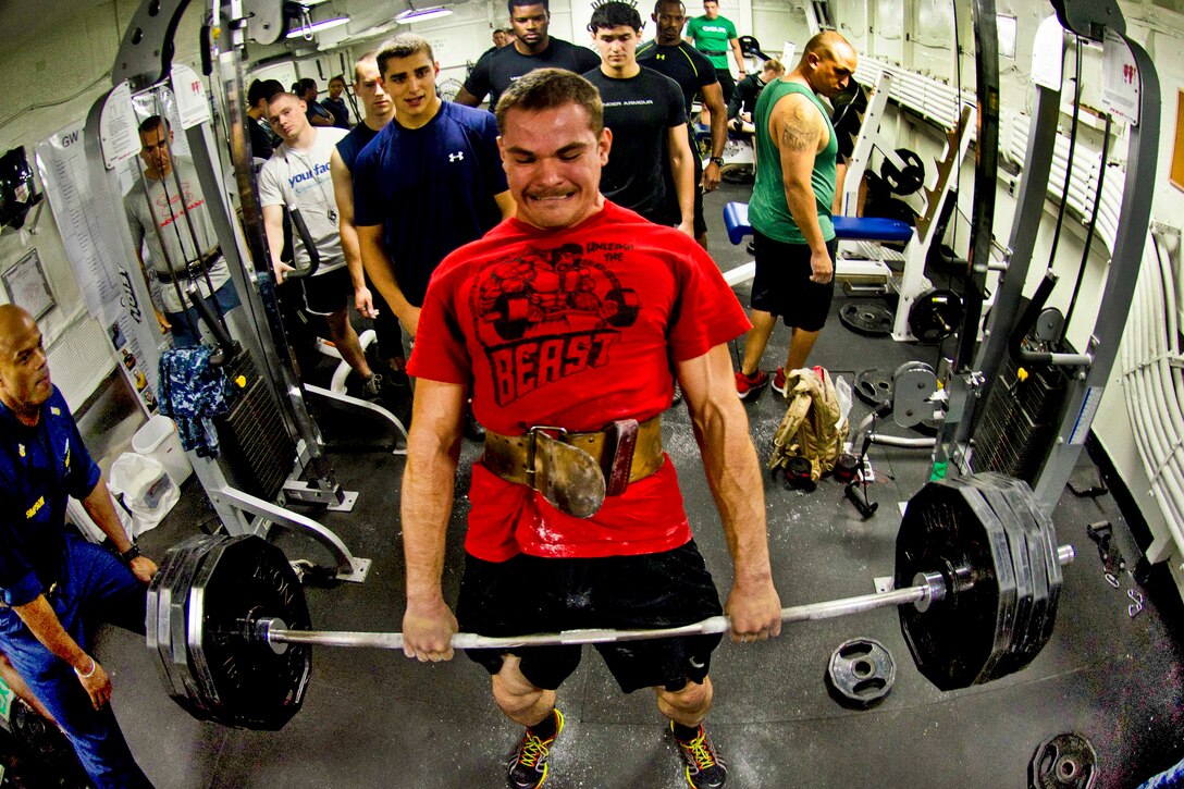 U.S. Navy Petty Officer 3rd Class Ben Burnell participates in a 1,000 pound challenge aboard the aircraft carrier USS George Washington in the Pacific Ocean, July 14, 2013. The Washington and its embarked air wing, Carrier Air Wing 5, provide a combat-ready force that protects and defends the collective maritime interest of the U.S. and its allies and partners in the Indo-Asia-Pacific region. Burnell is assigned to Strike Fighter Squadron 27.