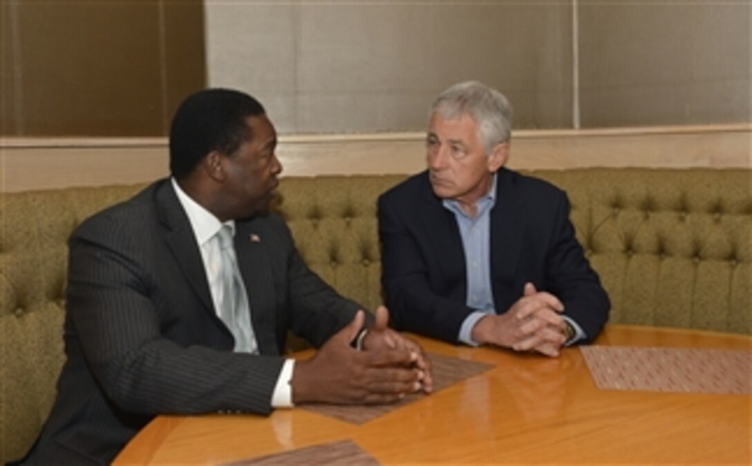 Secretary of Defense Chuck Hagel, right, meets with Mayor Alvin Brown of Jacksonville, Fla., on July 16, 2013.  Hagel met with Brown before leaving for a tour of Naval Air Station Jacksonville, Fla.  Hagel will visit the Air Station to conduct town hall meetings and receive briefings from Navy and civilian leaders on the impact of furloughs and sequestration on their lives and operations.  