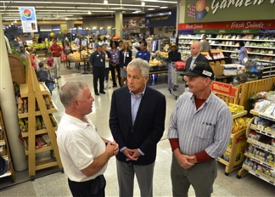 Secretary of Defense Chuck Hagel, center, is briefed by Jacksonville Commissary Director Larry Bentley, left, and John Crayon, right, manager of the meat department, as he is given a tour of the Naval Air Station Jacksonville, Fla., commissary on July 16, 2013.  Hagel is visiting the station to conduct town hall meetings and receive briefings from Navy and civilian leaders on the impact of furloughs and sequestration on their lives and operations.  